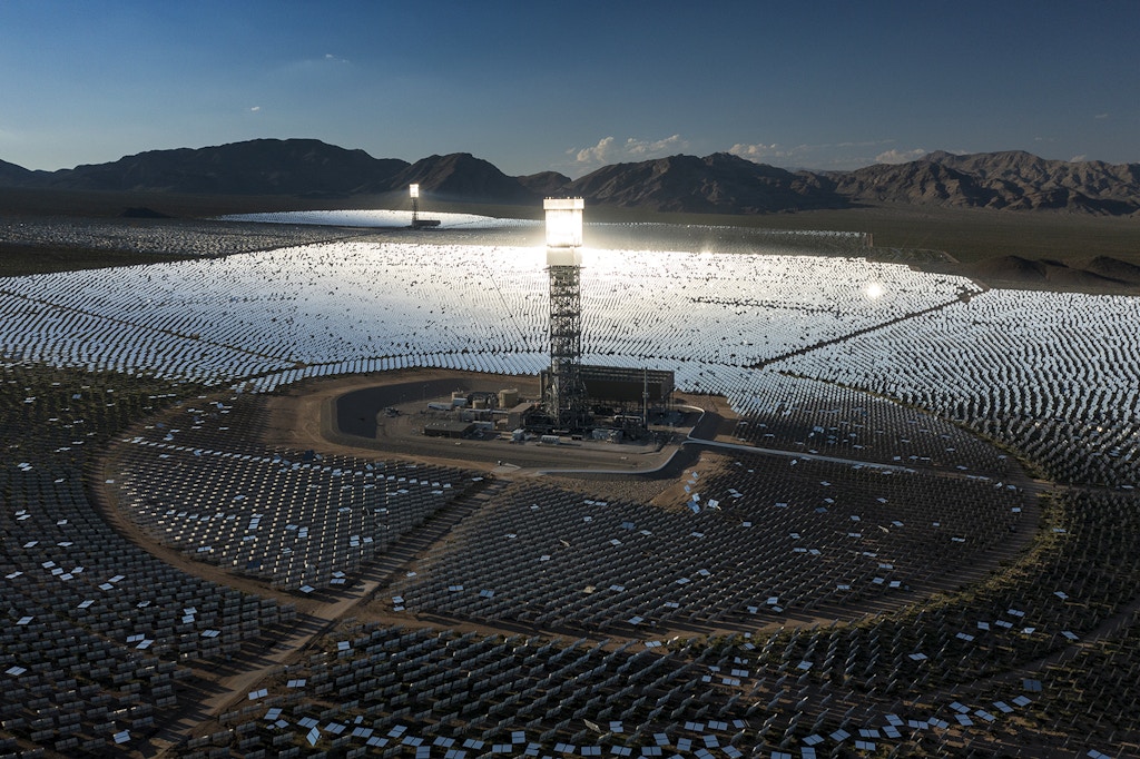 A boiler tower is surrounded by mirrors at the Ivanpah Solar Electric Generating System in the Mojave Desert on August 26, 2022 near Nipton, California.