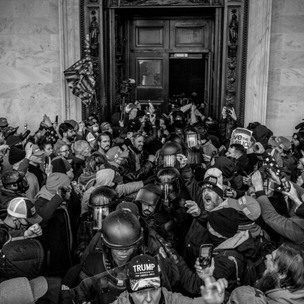 Protesters exit the Capitol after facing off with police in the Rotunda in Washington, D.C. after listening to a speech by President Trump on January 6, 2021. A large mob who convened on Washington, D.C. for a ?Save America? or ?Stop the Steal? rally was incited by President Trump and stormed the United States Capitol building, fighting with police, and damaging offices and rooms as they made their way through the building.As President Trump openly condoned the violence, the D.C, mayor called for a 6 p.m. curfew, and mobilized the National Guard. (Photo by Ashley Gilbertson / VII Photo)