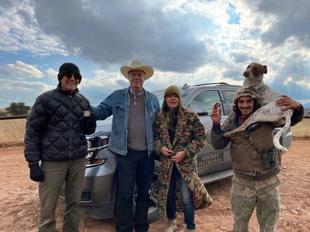 Public land defenders Andy Kayner, Kate Scott, and Ethan Bonnin visit with Santa Cruz County Sheriff David Hathaway at an encampment blocking Arizona Gov. Doug Ducey’s illegal wall of shipping containers. December 7, 2022.