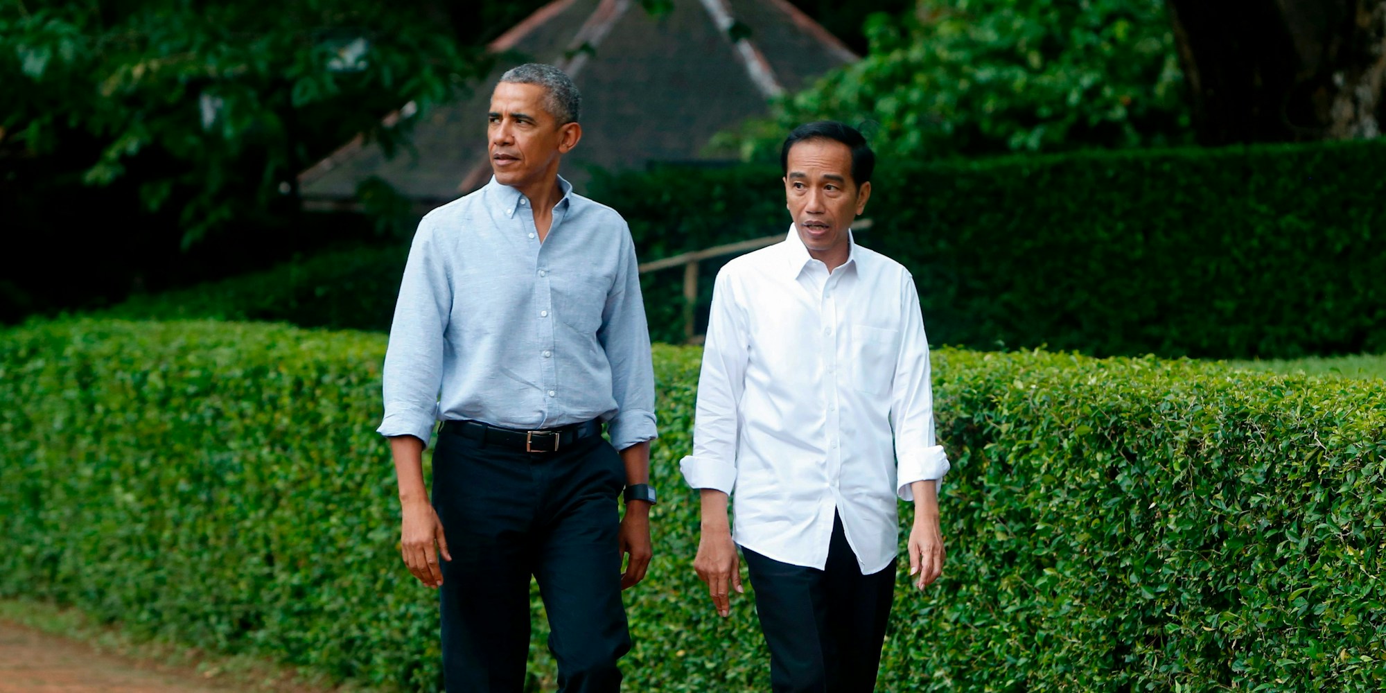 Former US president Barack Obama (L) walks next to Indonesian President Joko Widodo (R) during their a visit at the Botanical Garden adjacent to the Presidential Palace complex in Bogor on June 30, 2017. Obama is currently on a 10-day family holiday in Indonesia that will take take him to Bali and Jakarta, the city where he spent part of his childhood, officials said. / AFP PHOTO / POOL / ADI WEDA (Photo credit should read ADI WEDA/AFP via Getty Images)