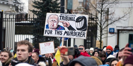Protesters hold placards during the demonstration outside the Russian embassy, Jan. 22, 2023 in Warsaw, Poland.
