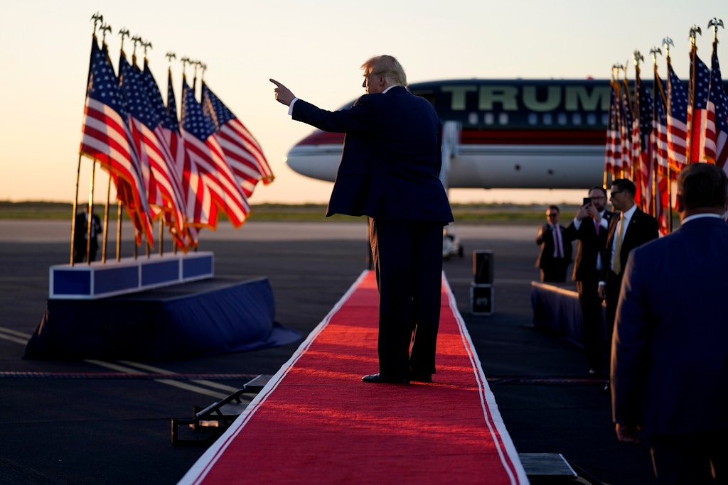 Former President Donald Trump points to the crowd as he leaves after speaking at a campaign rally, March 25, 2023, in Waco, Texas.