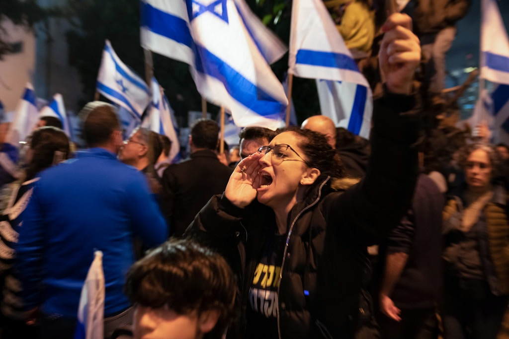 Israeli protestor shouts during an anti reform demonstration in Tel Aviv, Israel, Mar. 25th 2023.