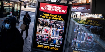 A billboard on a bus stop advertises a message from the Federal Bureau of Investigation seeking information related to violence at the U.S. Capitol, on January 9, 2021 in Washington, DC.