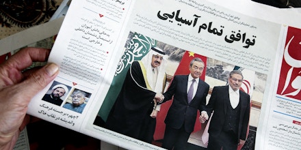 A man in Tehran holds a local newspaper reporting on its front page the China-brokered deal between Iran and Saudi Arabia to restore diplomatic relations, signed in Beijing the previous day, on March, 11 2023.lds a local newspaper reporting on its front page the China-brokered deal between Iran and Saudi Arabia to restore diplomatic relations, signed in Beijing the previous day, on March, 11 2023.