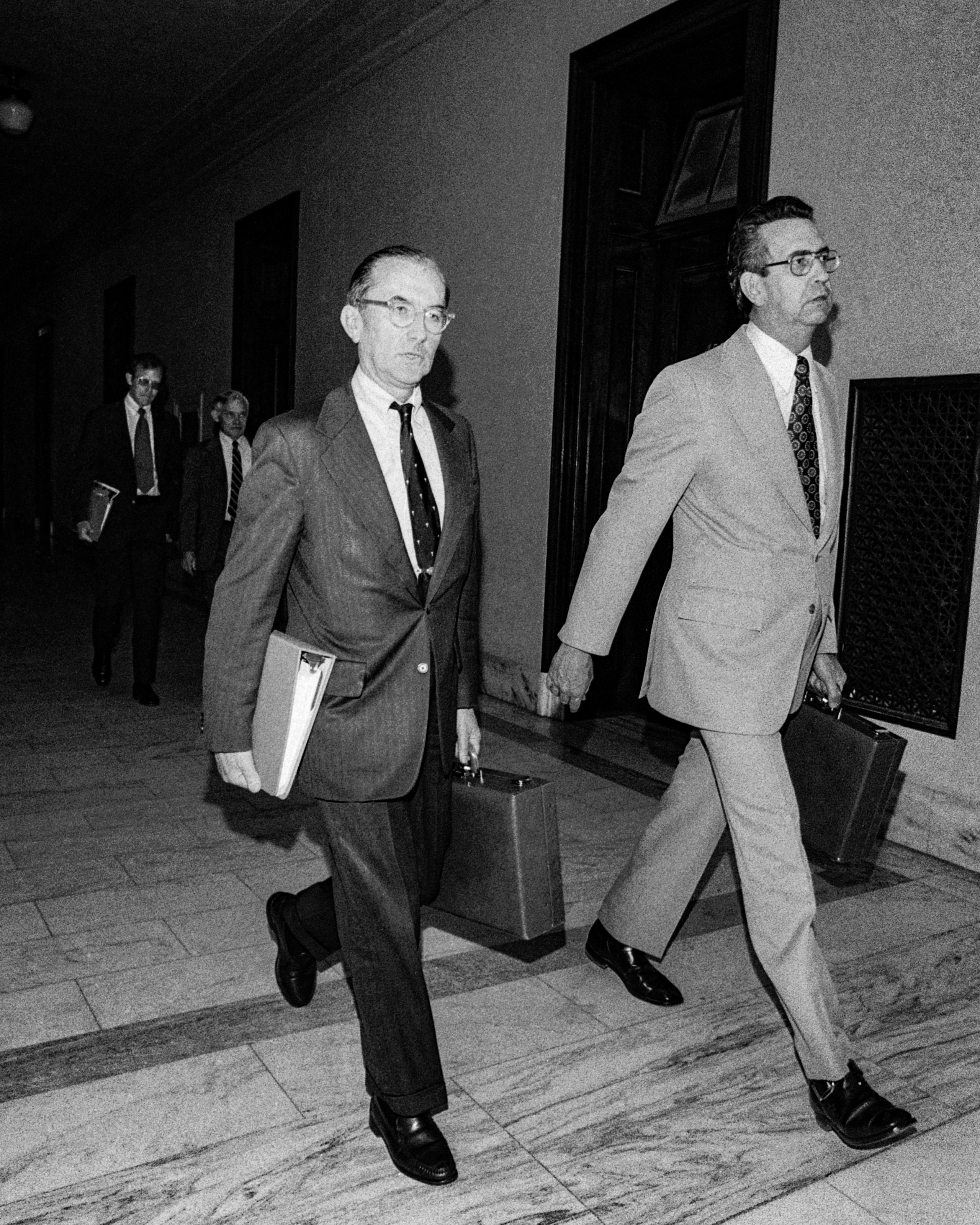 (Original Caption) Central Intelligence Agency Director William Colby, left, arrives for questioning by the Senate Intelligence Commitee 5/21, accompanied by George Cary, legislative counsel for the CIA. After the closed session Sen. Frank Church, D-Idaho, commitee chairman, said a key topic was alleged agency involvement in assassination plots.